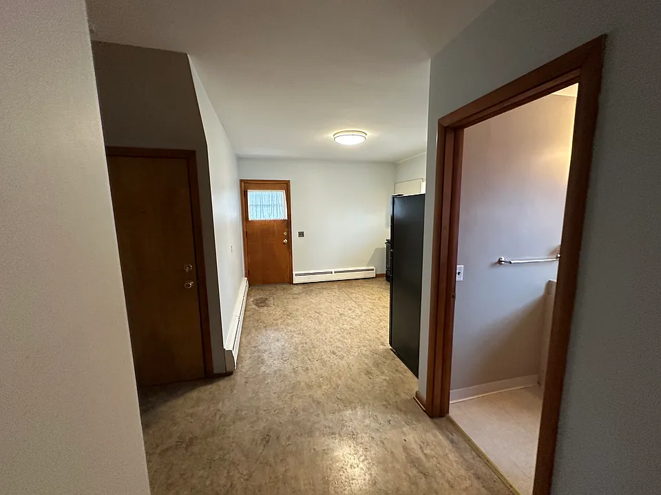 Hallway leading to the rooms and kitchen.