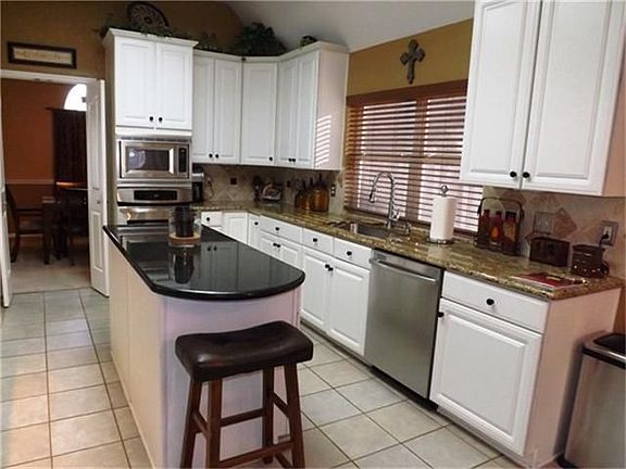 WOW! What a kitchen. Counter space galore plus the center island