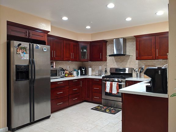 Large U kitchen with lots of storage. Included Appliances: Side-by-side refrigerator, Gas cook top and convection-oven. High speed and stylish glass range hood.