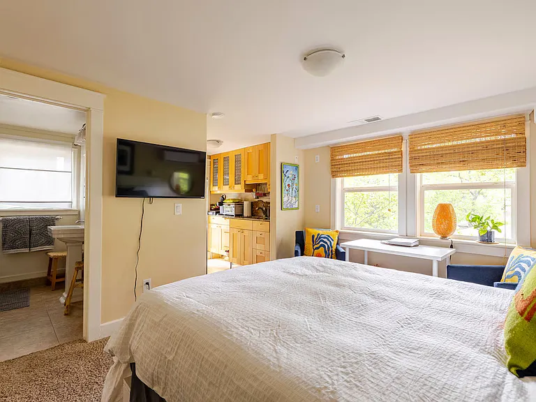 40 inch TV. You can stream your subscriptions. Comfy queen bed with 6 large drawers in the frame for storage. Bed faces the opening to the kitchen and to the bathroom.