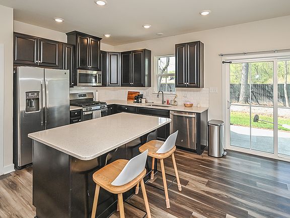 Beautiful open kitchen with stainless steel appliances, granite countertops ,and subway tile backsplash