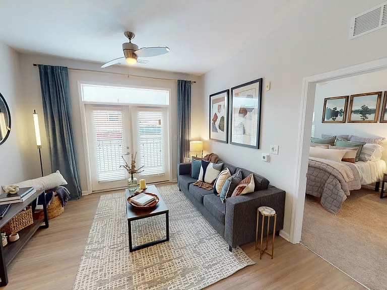 Open-Concept Living Room and Cozy Bedroom at Ralston Apartments in Downtown Indianapolis