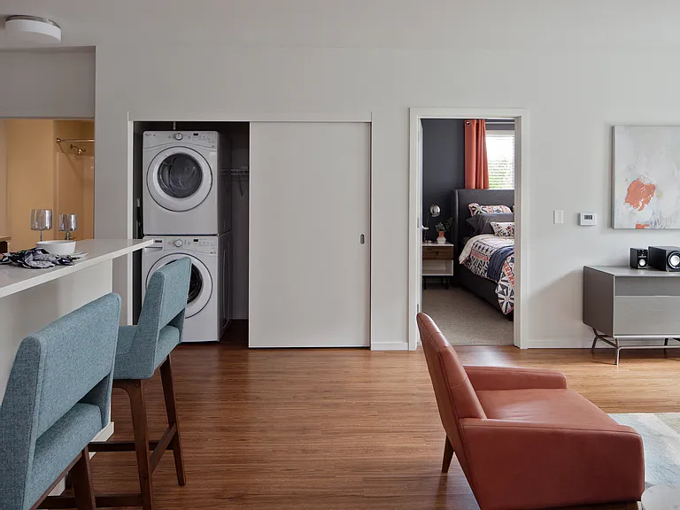 Grant park village kitchen bar and orange chair with washer and dryer in background