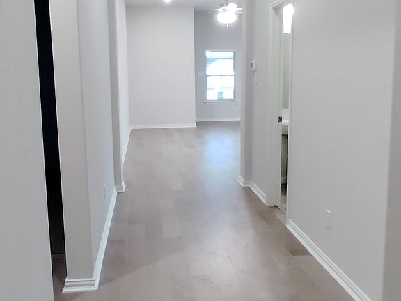 Long, tall, and wide entry hall with overhead lighting