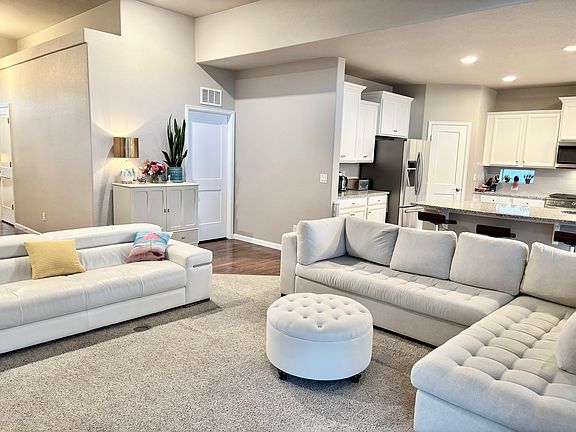 Open concept primary living level with kitchen, living room, dining room, primary suite and guest room and bath