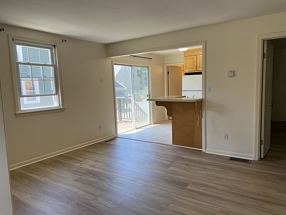 Living area- with BRAND NEW Vinyl plank flooring. Living space connects to kitchen.