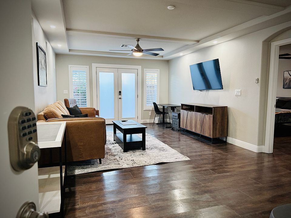 Enter through your own keypad private entrance to a wonderful living room, work space, kitchen area w/ backyard access.