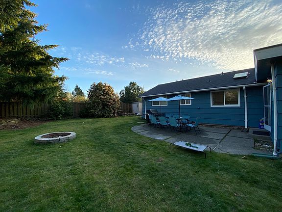 Massive fully fenced in backyard with firepit.