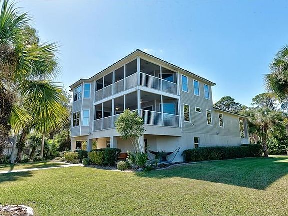 Lush tropical landscaped property - over 1/2 acre.  Windows throughout -Hello Sunshine!  Fully fenced yard.  No community rules 