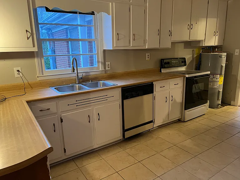 Kitchen and many, many cabinets. 
All freshly painted. View from sizeable paneled den.