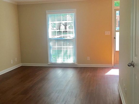 Spacious living area with plantation shutters / storm door