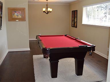 Large living/dining/or gameroom. This room could even be your study. Pool table/accessories are for 