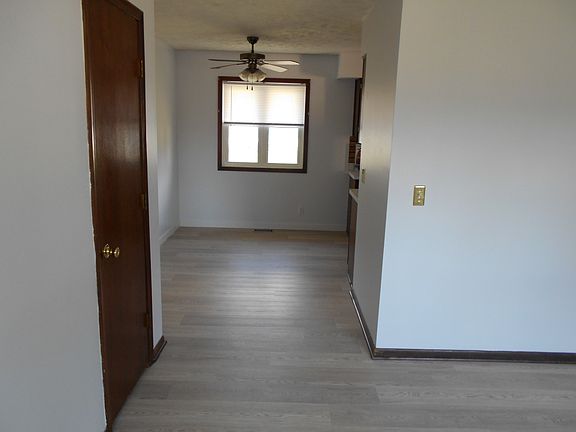 front door to dining area
with fan and window blinds