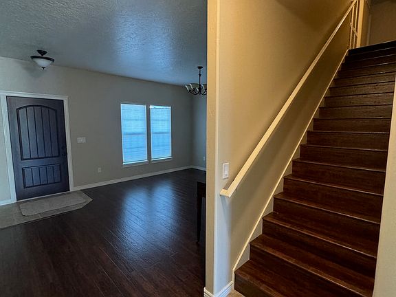 Front door, stairs, Front room can be used as formal dining or Living room