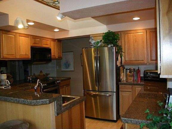Totally remodeled kitchen has granite counter tops and top of the line Canyon Creek hickory cabinets