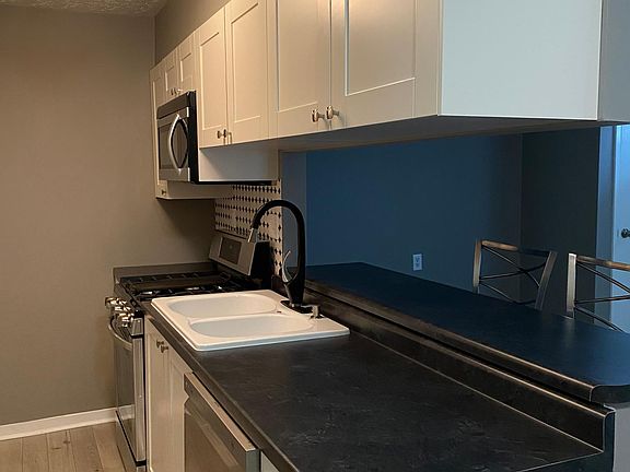 New counter tops, kitchen sink, faucet, microwave.