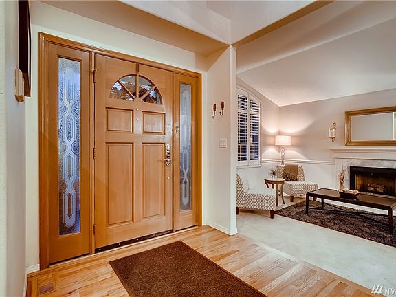 Lovely foyer boasts beautiful hardwoods and tall ceilings.