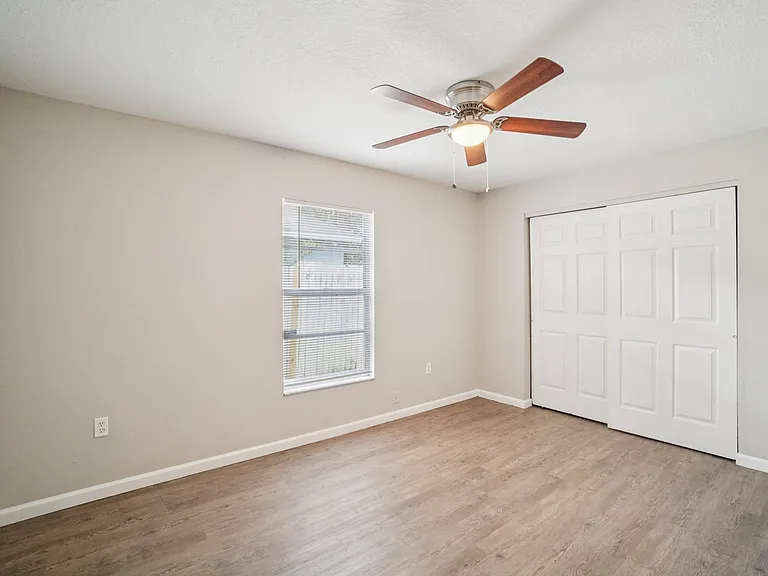 Comfortable third bedroom, ideal for a home office or nursery, with ample closet space.