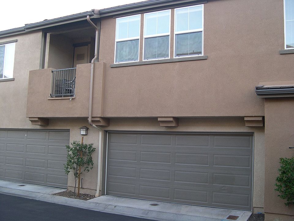 Front shows garage and balcony