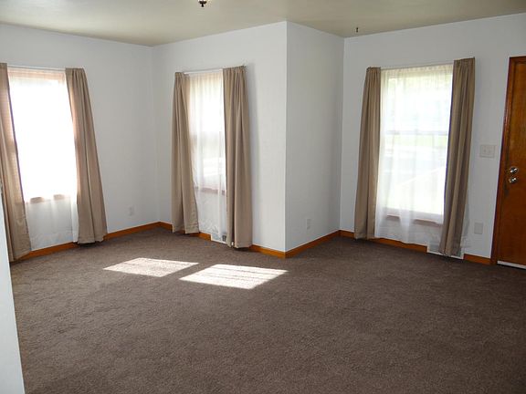 Living room features three large windows allowing for lots of natural lighting.