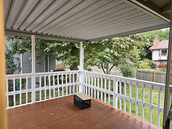 A deck extended from the kitchen, nice view with a shade
