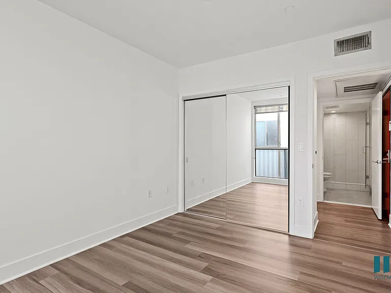 Bedroom with Mirrored Closet and Vinyl Flooring