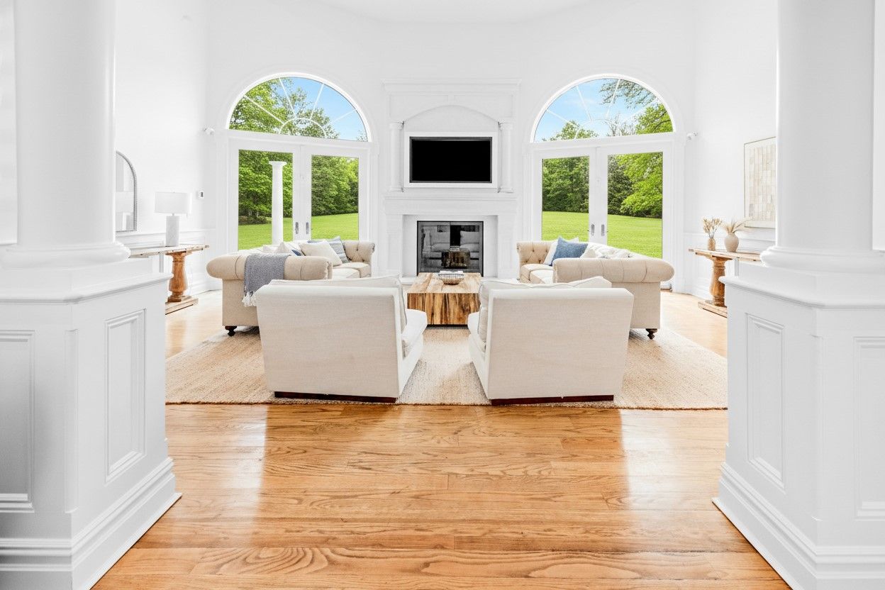  Grand living space filled with sunlight and dramatic ceiling heights