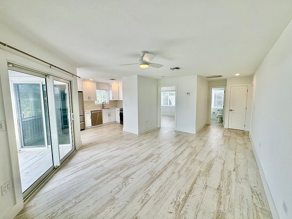 Looking toward balcony, kitchen, bedroom and bathroom.