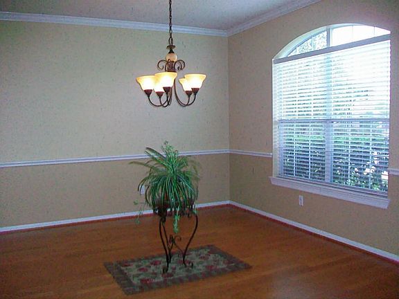 FORMAL DINING WITH HARDWOOD FLOORING, & LOVELY LIGHT FIXTURE