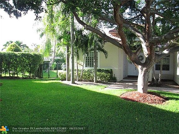 NW View Showcases Green LawnWest Yard Gated Entrance To Fully Fenced Side And Rear Yards