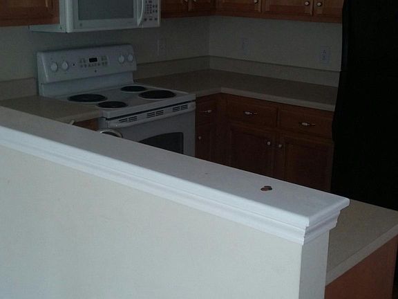 Kitchen has stove, refrigerator, microwave and dishwasher