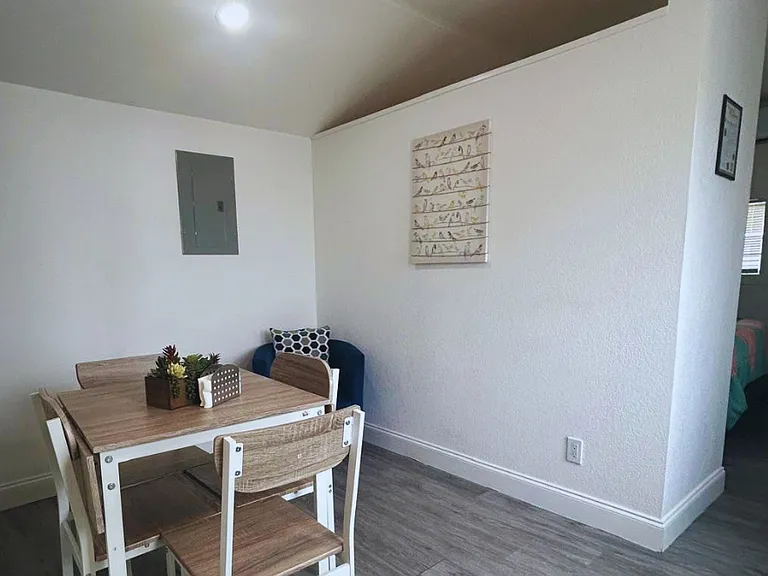 Dining area with 4 chairs and a homely accent chair.