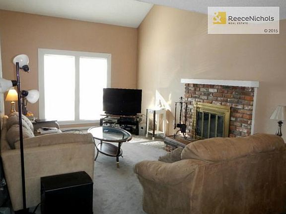 Great Room with soaring ceilings, fireplace, new windows is open