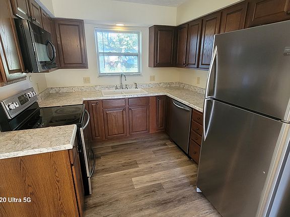 Kitchen with stainless steel appliances - including Refrigerator, oven/range, microwave and dishwasher.