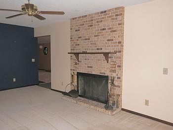 Large living room offers brick wood burning fireplace