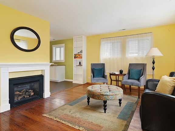 Living room with gas fireplace & hardwood floors.