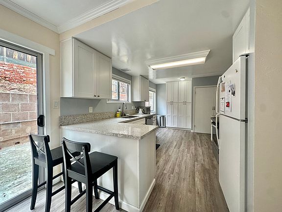 Kitchen leads to formal dining and 300SF private outdoor space.