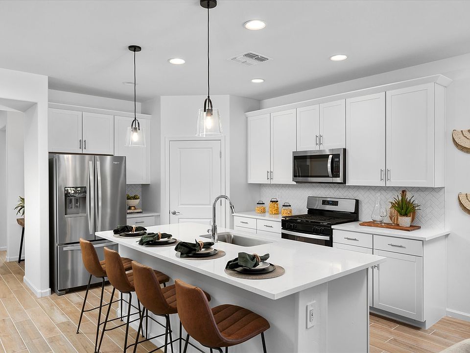Enjoy an open concept kitchen complete with a suite of Whirlpool R appliances.