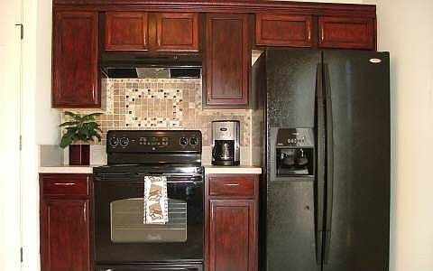 Beutiful Custom Cabinets and Tumblestone Marble Backsplash