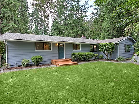 Inside, gleaming bamboo flooring can be found throughout the main level along with white millwork & more. The main-floor master suite is a tranquil retreat with a gorgeous ensuite bath & another set of glass French doors leading to a private deck. On the lower floor, a family room provides more gathering space along with two additional guestrooms and an updated bath. Finally, you'll find room for all your toys in the large 2-car garage plus a large, covered RV-height carport.