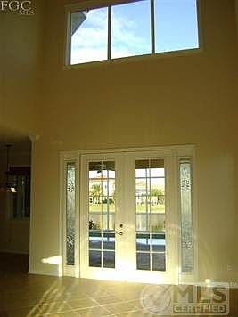big entrance looking straight thru lanai, pool to pond.