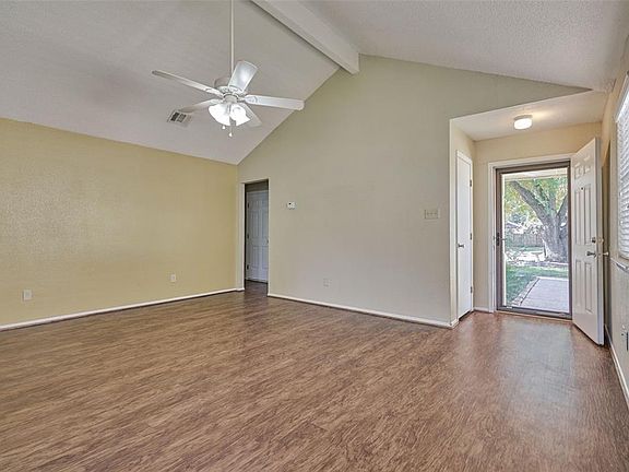Large living area with vaulted ceilings and a wall of windows.