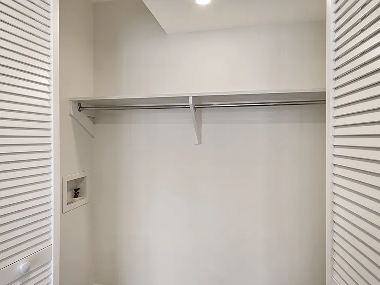 Full size washer and dryer closet adjacent to the kitchen.