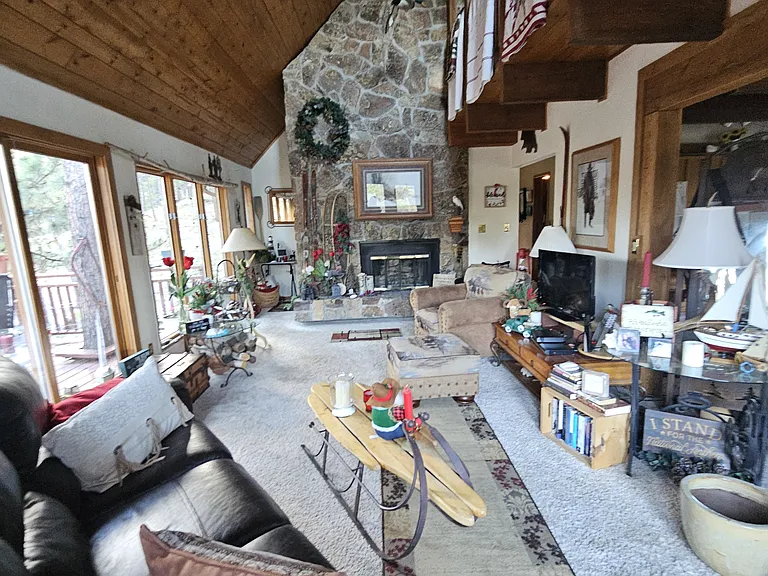 Front door entrance on 2nd floor. Loft is where quilts are hung. Entrance to third floor loft is behind the fireplace. Fully furnished balcony wraps around second floor deck. Which you may use year round.
