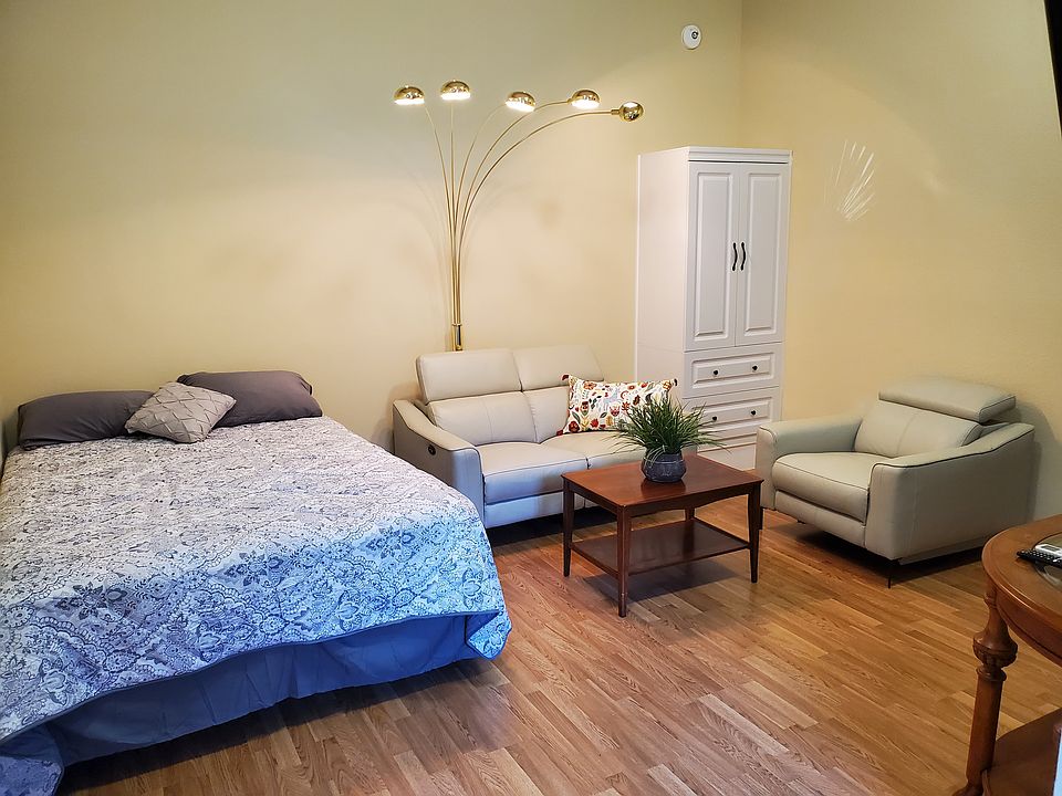 The studio has a queen-sized bed, a Living Spaces electric recliner leather sofa and chair, Armoire wardrobe closet with room to hang clothes and drawers underneath.