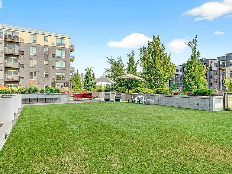 Enjoy open green space and shaded seating in our outdoor lawn and lounge area, perfect for relaxing or catching up with friends.
