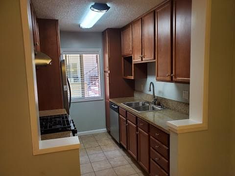 Kitchen includes fridge, gas stove, microwave, dishwasher.