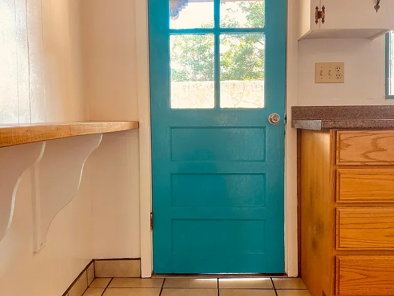 backdoor out of the kitchen onto the east side patio. Kitchen is tile floored with a side eating counter.