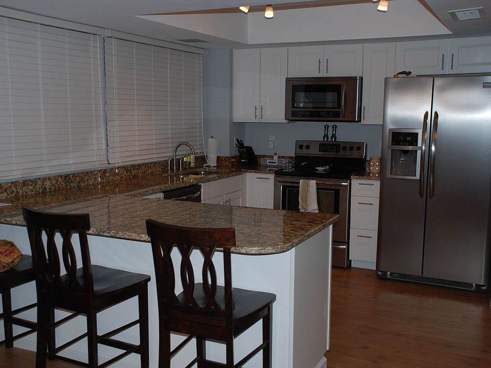 Updated kitchen with granite countertops and stainless steel appliances.