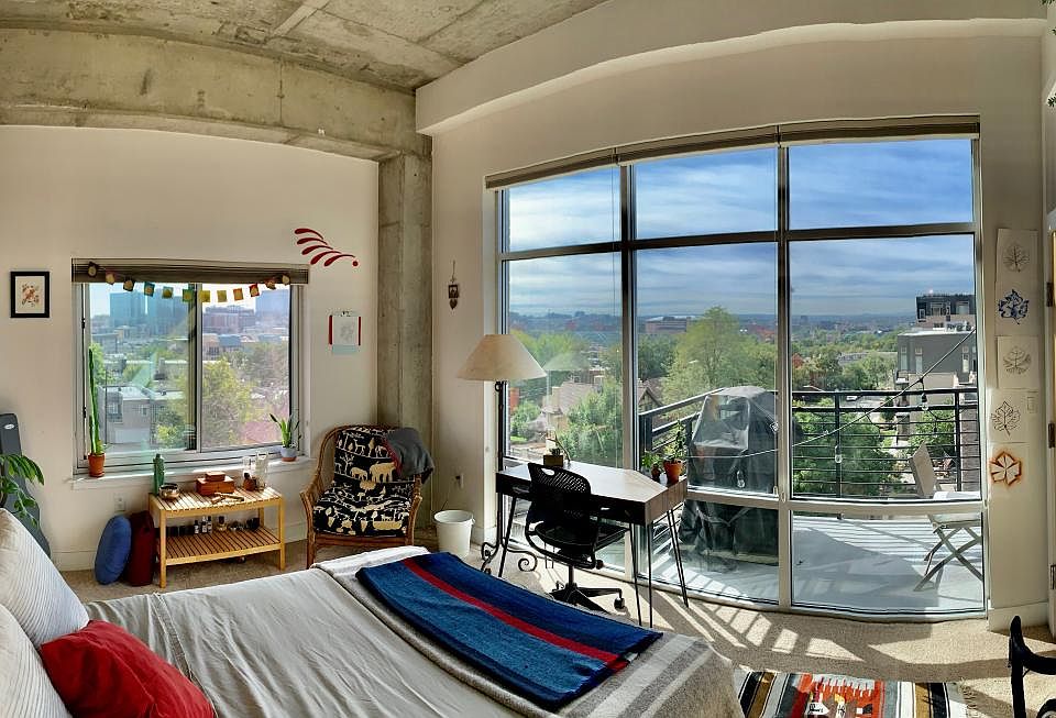 Enjoy sweeping city views with spacious 12ft ceilings and exposed concrete